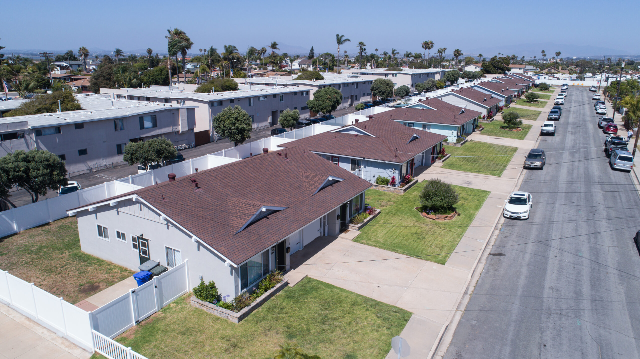 Gallery Aerial view of The Dahlia Coastal Bungalows duplex rental community and residential neighborhood in Imperial Beach, California.