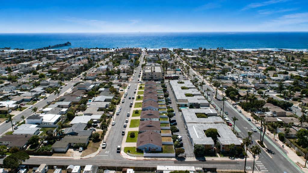 Home Aerial view of The Dahlia Coastal Bungalows residential community in Imperial Beach, California, near the Pacific Ocean.