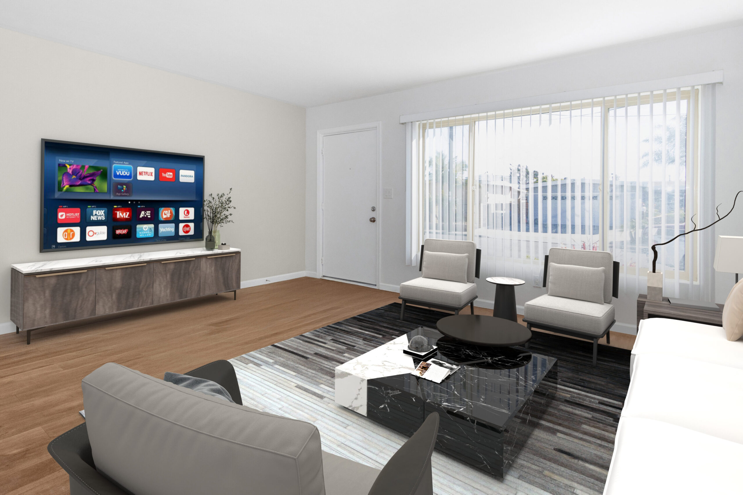 Home Thoughtfully designed living room in a Dahlia Coastal Bungalows residence with contemporary furnishings, large windows, and wood-look flooring.