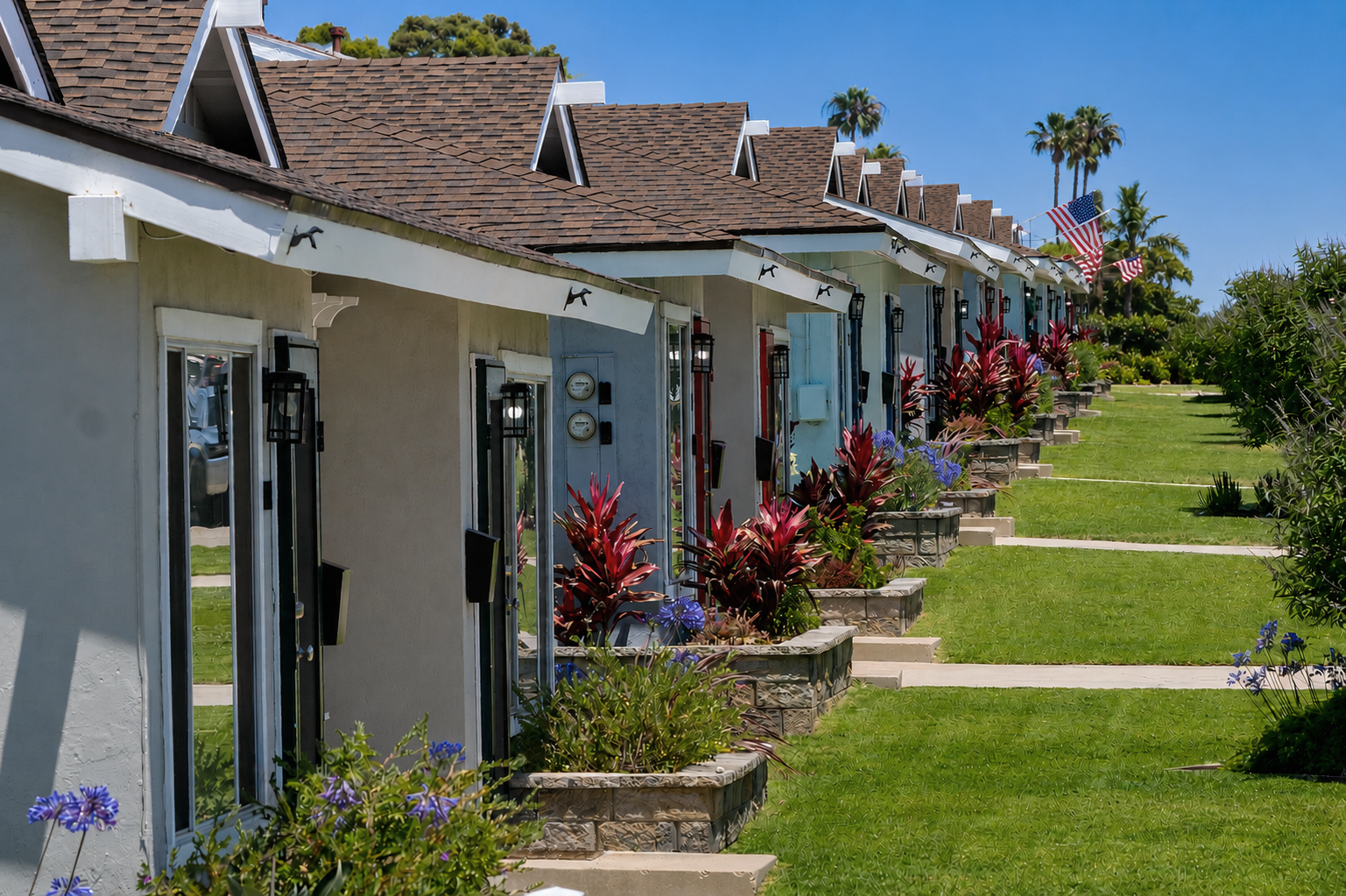 Home Row of sunny coastal bungalow residences with landscaped grounds at The Dahlia in Imperial Beach.