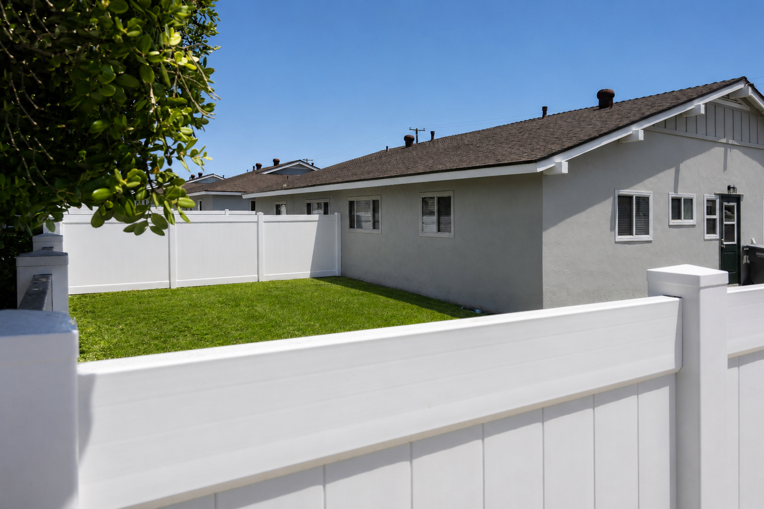 Gallery Private fenced backyard with lawn and exterior view of an Imperial Beach rental residence.