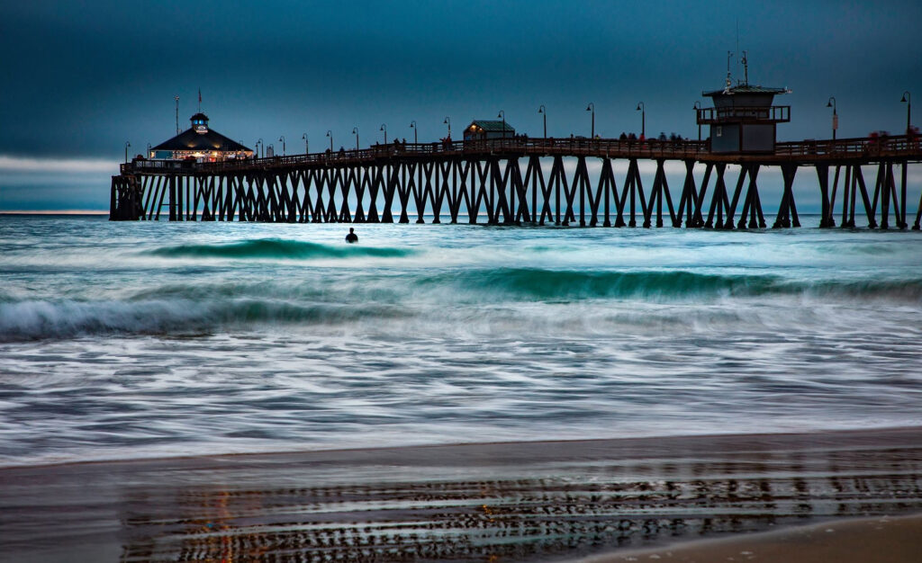 Imperial Beach Pier extends over ocean waves along the California coastline.
