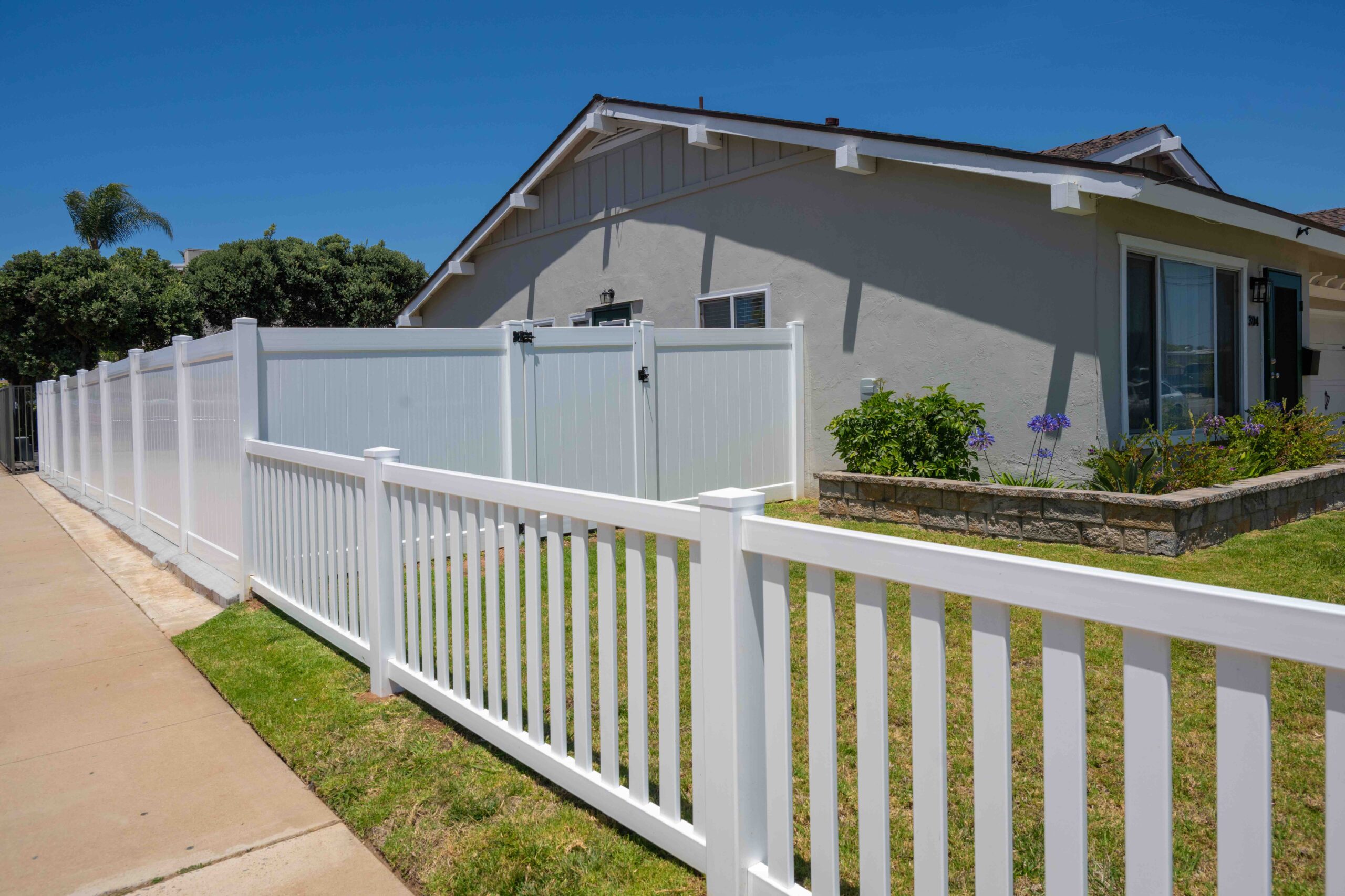 Gallery Fenced backyard with a white picket fence walkway alongside a duplex rental residence in Imperial Beach.